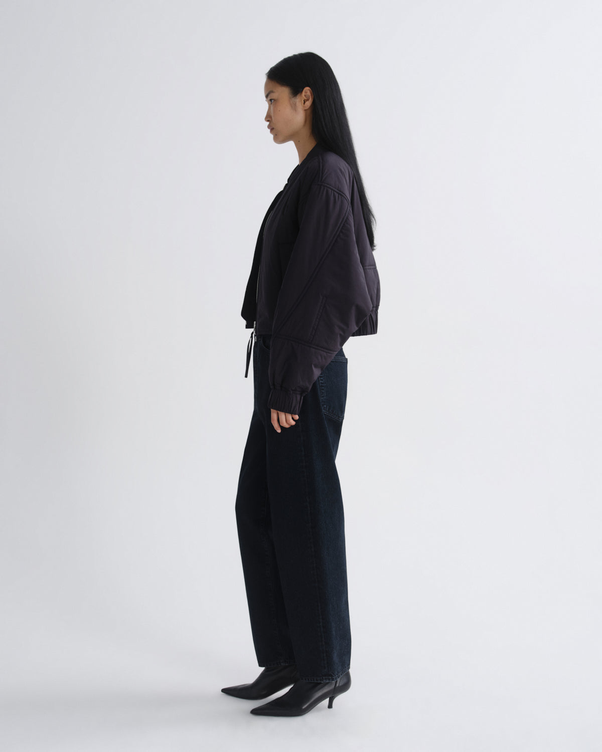 Person wearing a black outfit on a white background