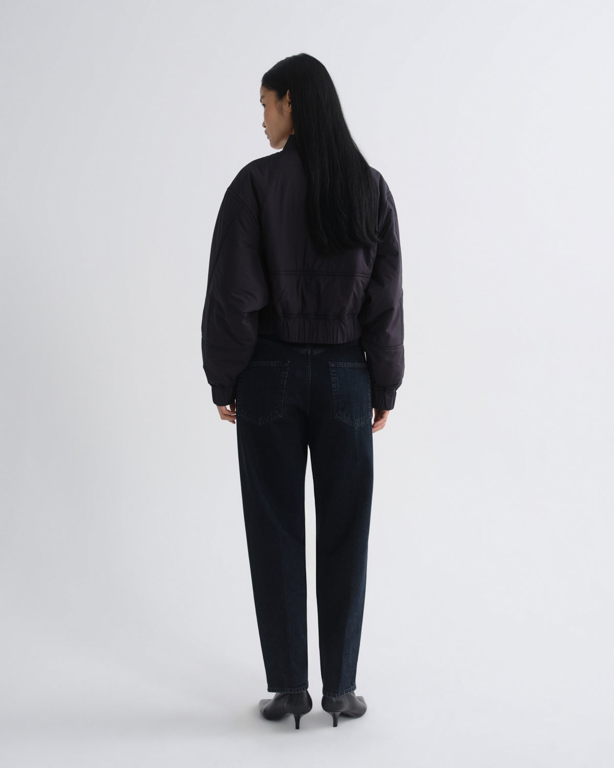 Person wearing a black outfit on a white background