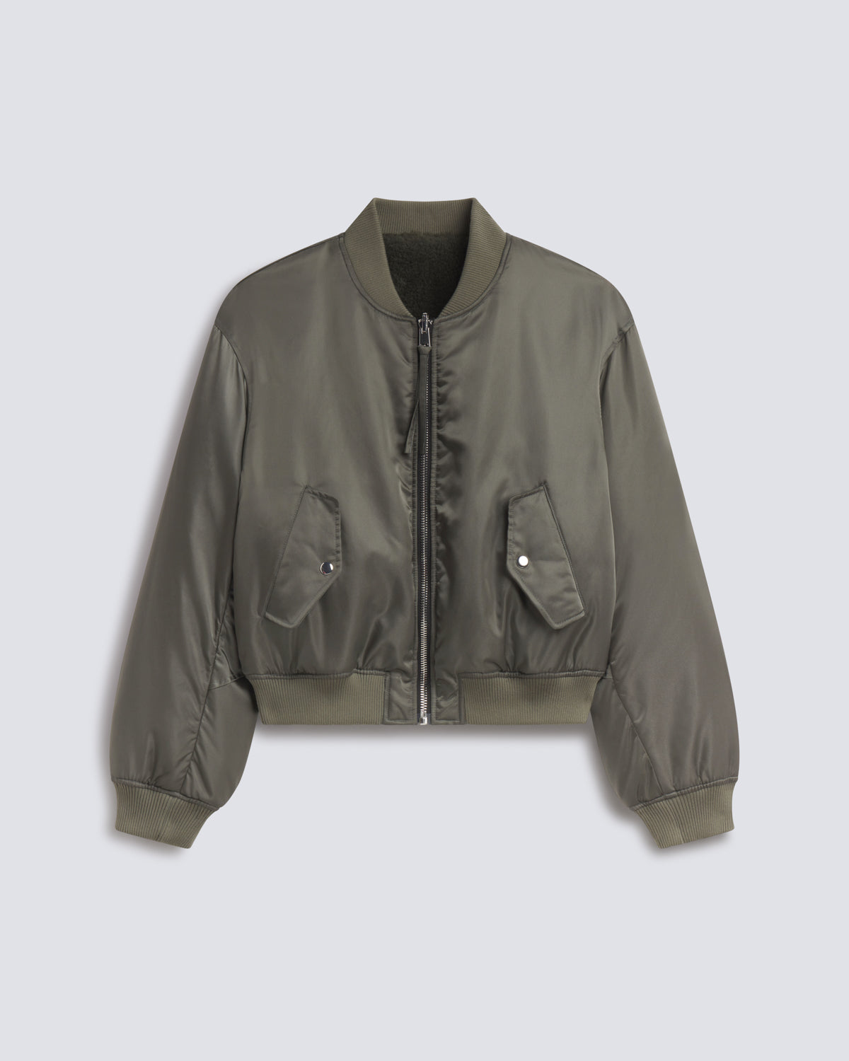 An olive green nylon bomber jacket with a front zipper, ribbed collar, cuffs, and hem, featuring two front flap pockets, displayed against a light gray background.