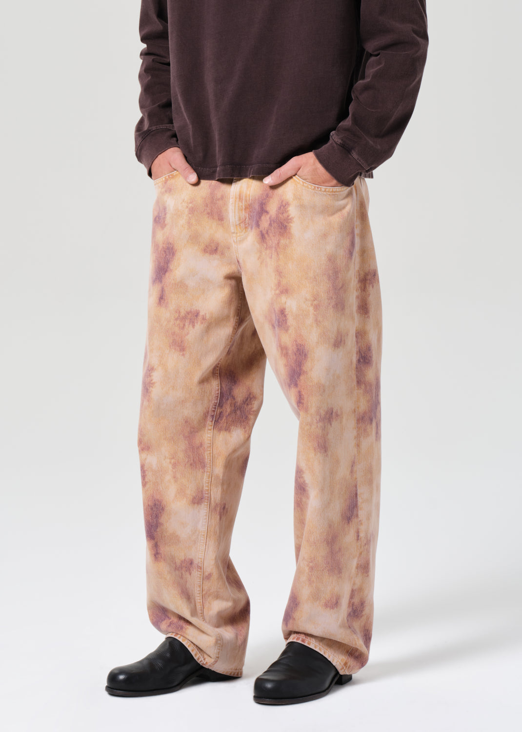 Person wearing a pair of patterned pants on a white background