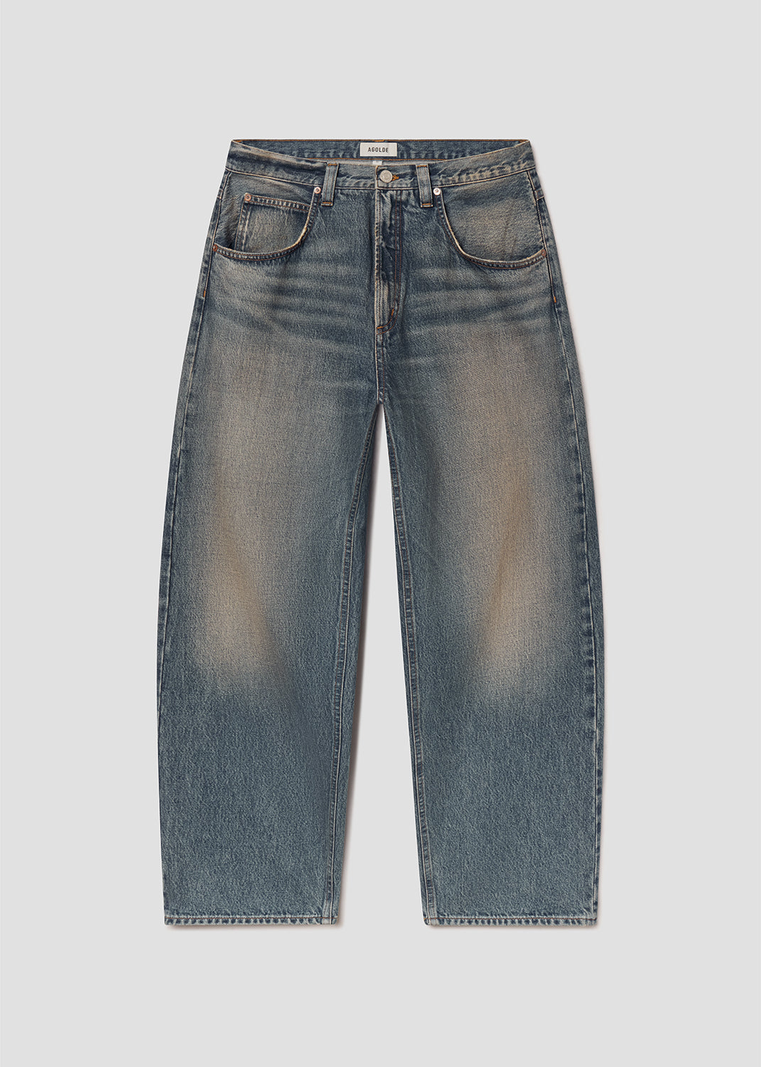 Flat lay of blue jeans on a grey background