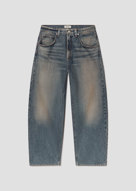 Flat lay of blue jeans on a grey background