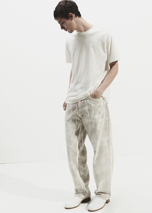 Person wearing a plain white t-shirt and light-colored pants on a white background