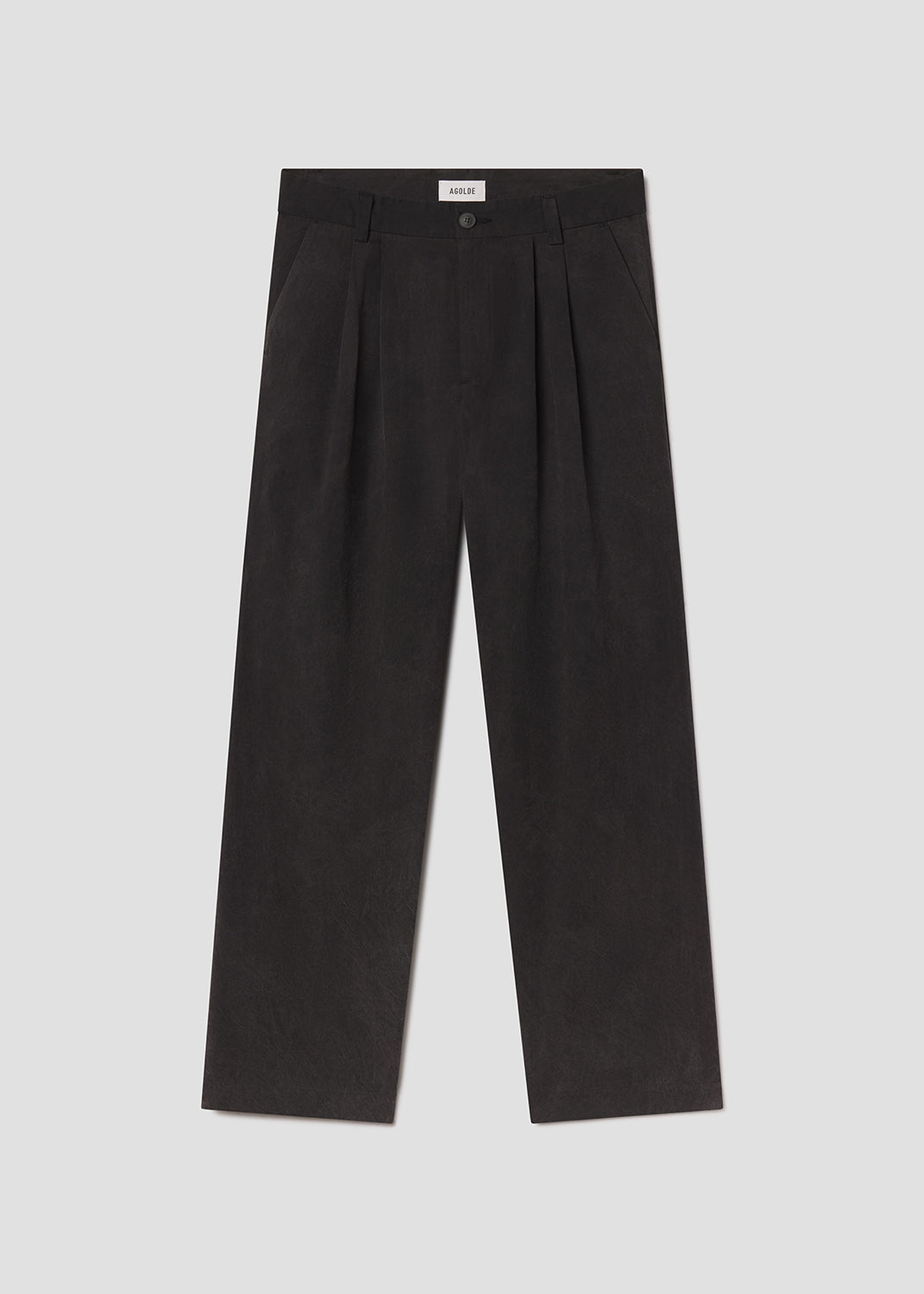 Flat lay of black pants on a grey background
