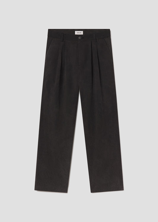 Flat lay of black pants on a grey background