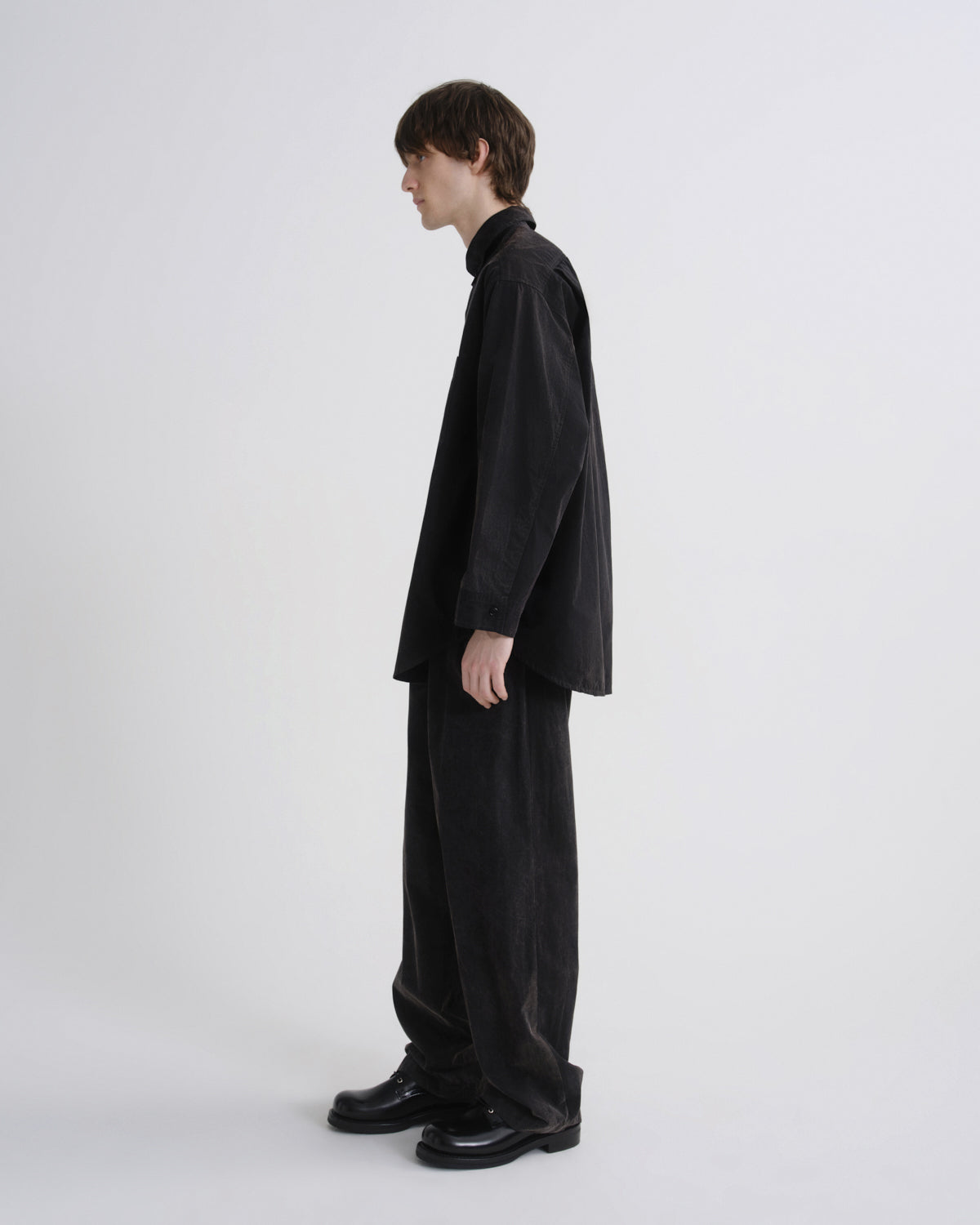 Person wearing a black outfit on a white background