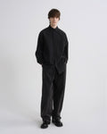 Person wearing a black outfit on a white background