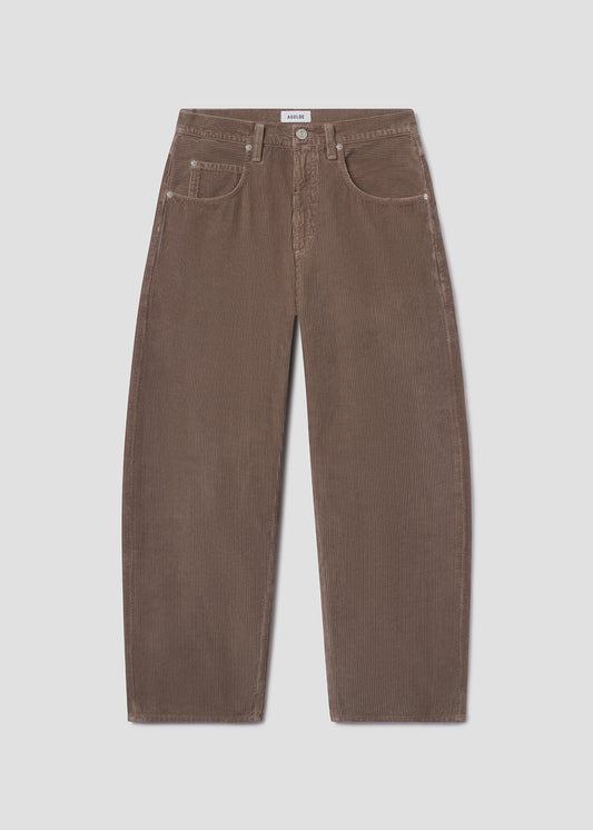 Flat lay shot of brown jeans on a grey background