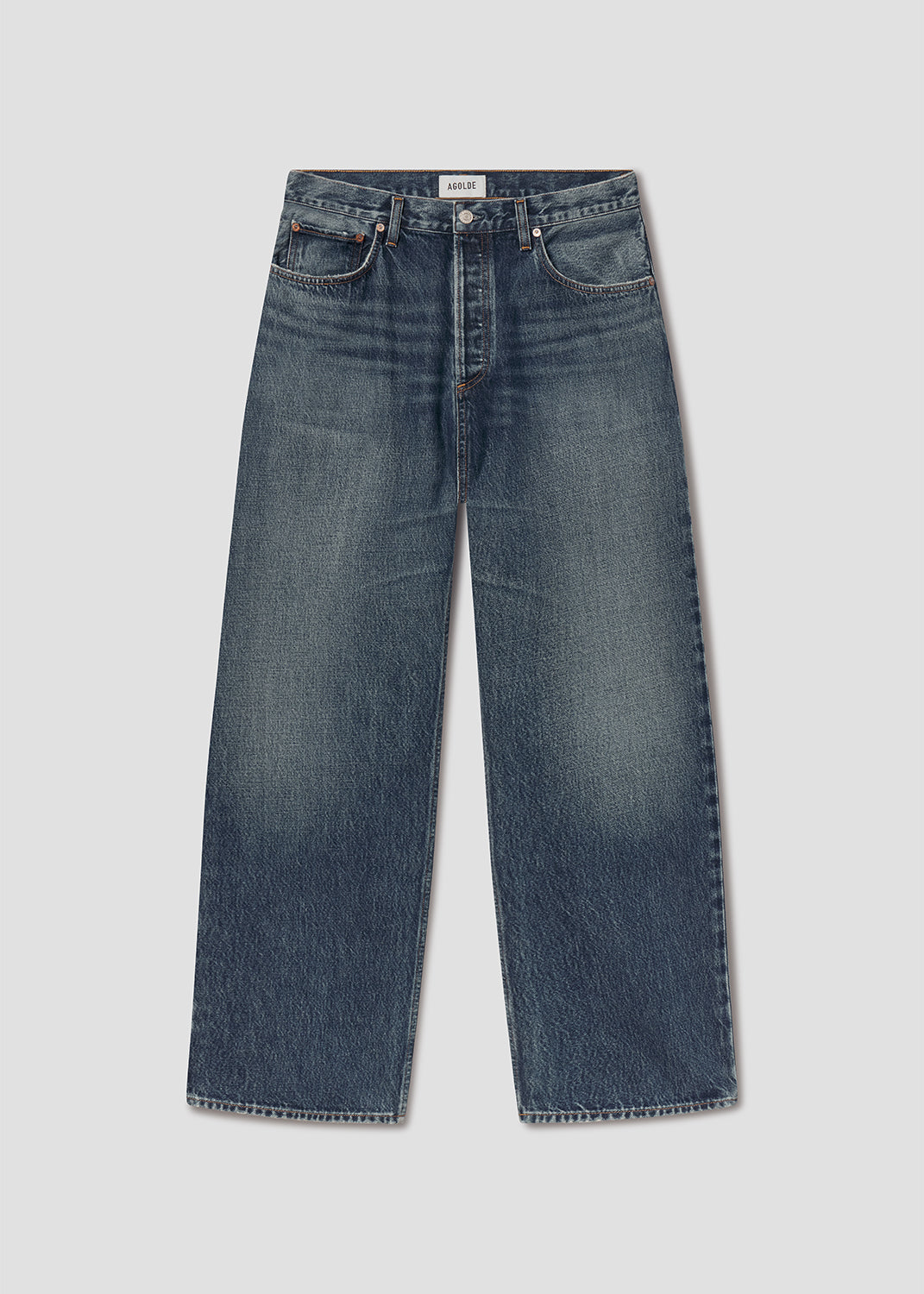 Flat lay of blue jeans on a grey background