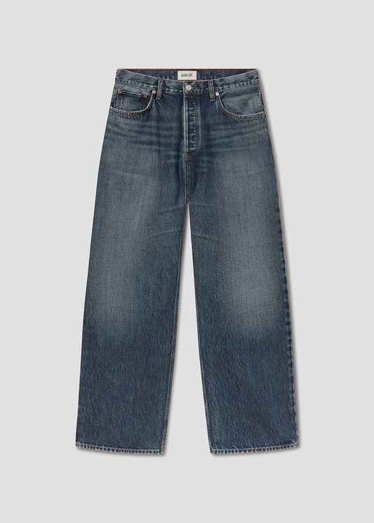 Flat lay of blue jeans on a grey background