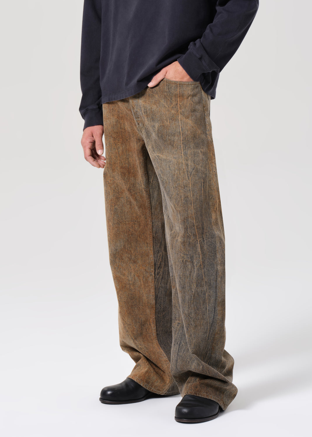 Person wearing brown corduroy pants on a white background