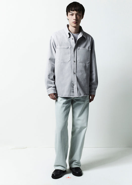 Person wearing a light gray shirt and pants on a white background
