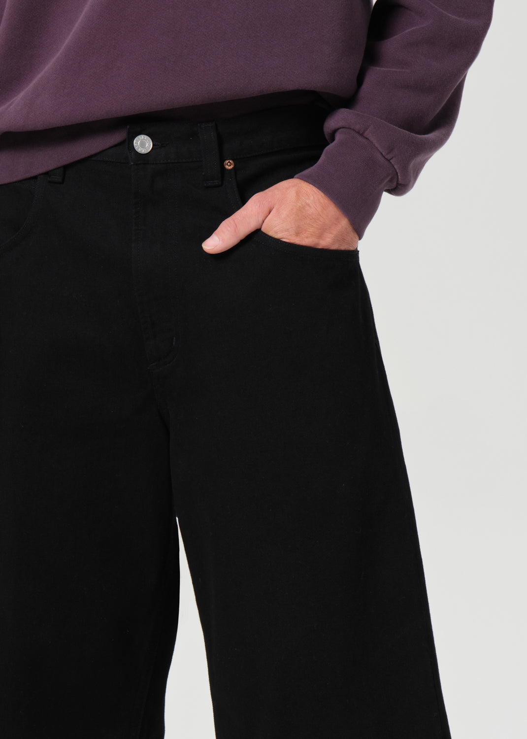 Person wearing black pants with a blurred background