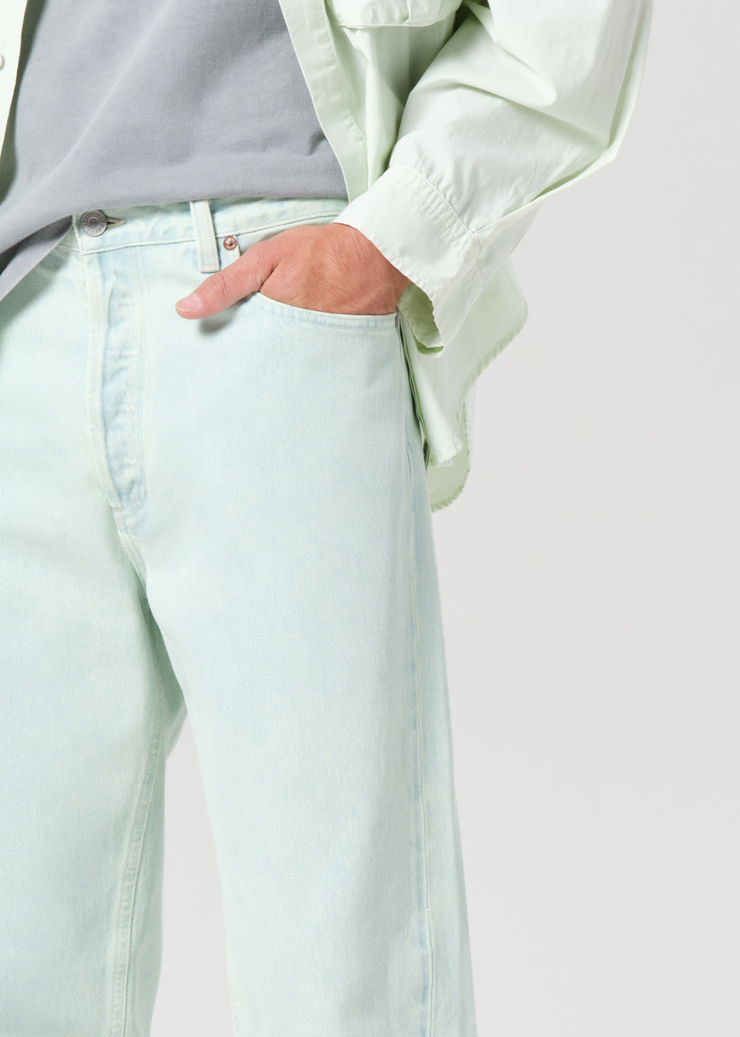 Light blue jeans worn by a person with a neutral background
