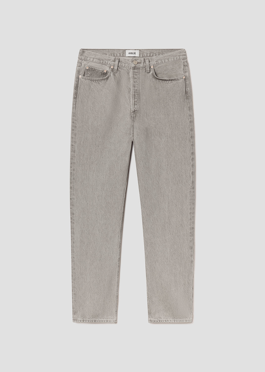 Flat lay of grey jeans on a grey background