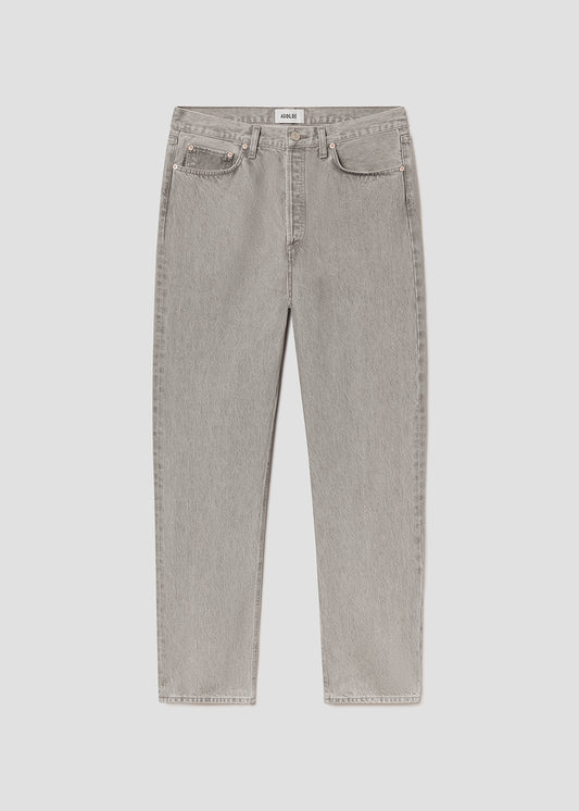 Flat lay of grey jeans on a grey background