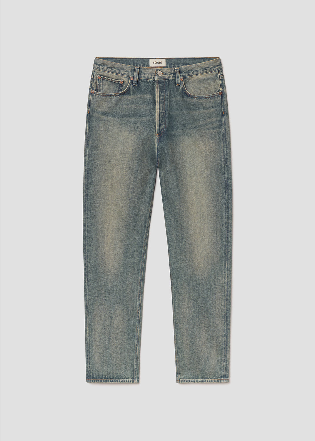 Flat lay of blue jeans on a grey background