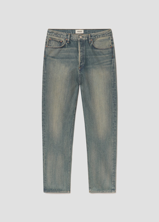 Flat lay of blue jeans on a grey background