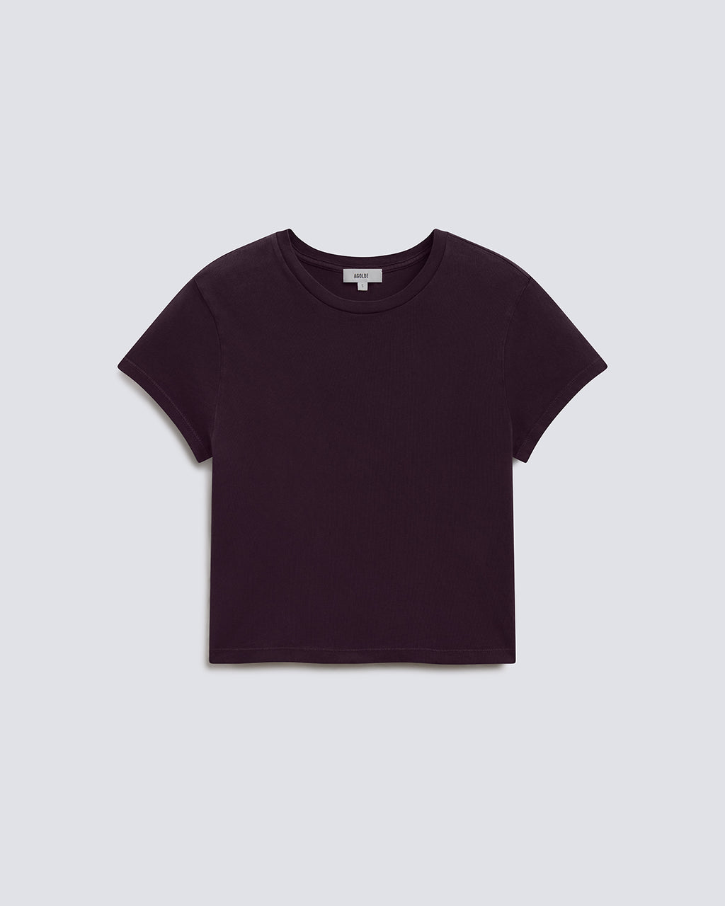 A dark plum purple short-sleeve crop top t-shirt, laid flat against a light gray background.