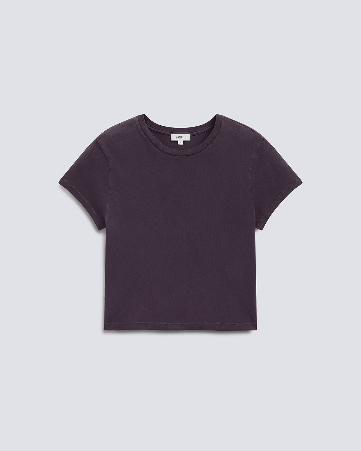A dark plum purple short-sleeve crop top t-shirt, laid flat against a light gray background.