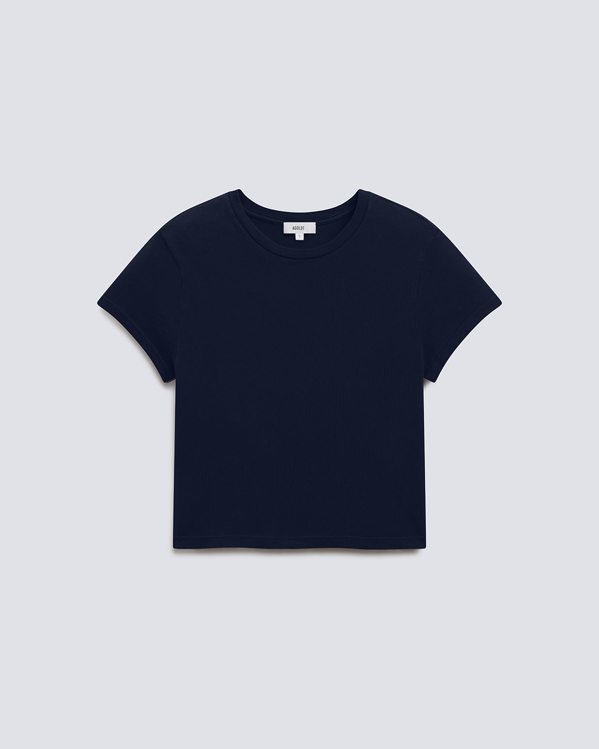 A cropped short-sleeve crewneck t-shirt in solid navy blue, displayed flat against a light gray background.