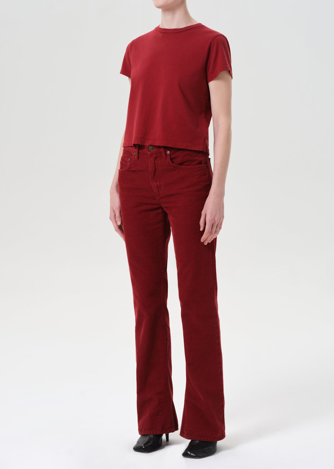 Person wearing a red t-shirt and red pants on a white background