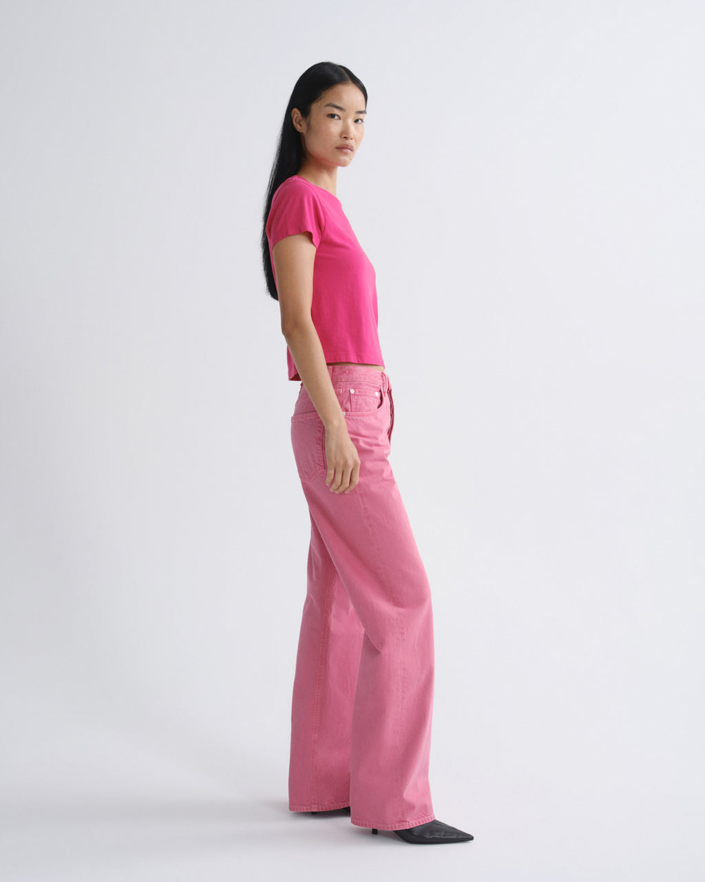 Person wearing a pink outfit on a white background