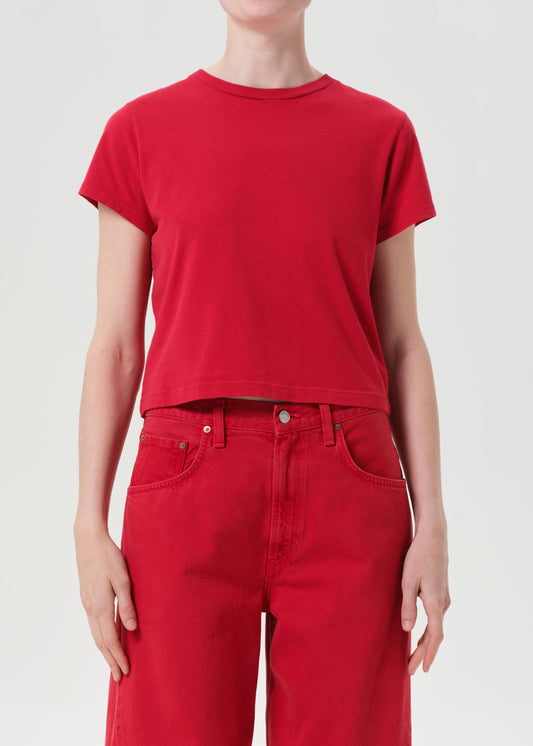 Person wearing a red t-shirt and red pants on a white background
