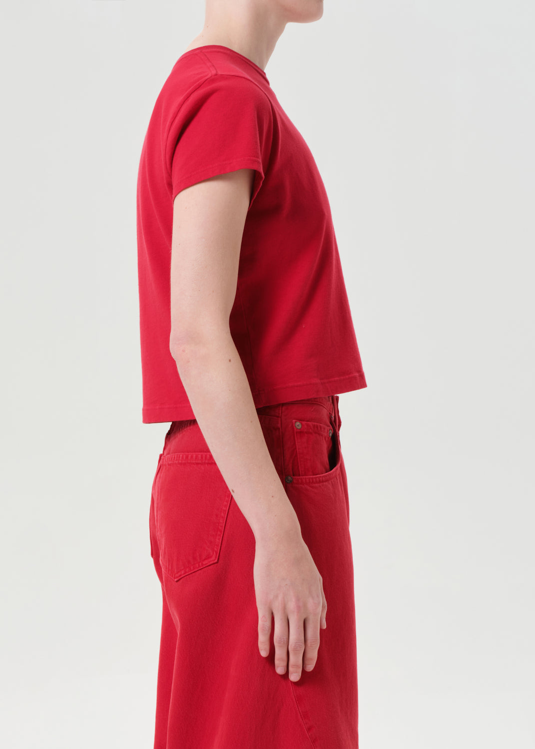 Person wearing a red outfit on a light gray background