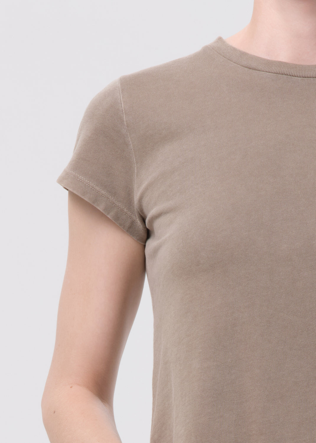Brown t-shirt worn by a person on a light gray background
