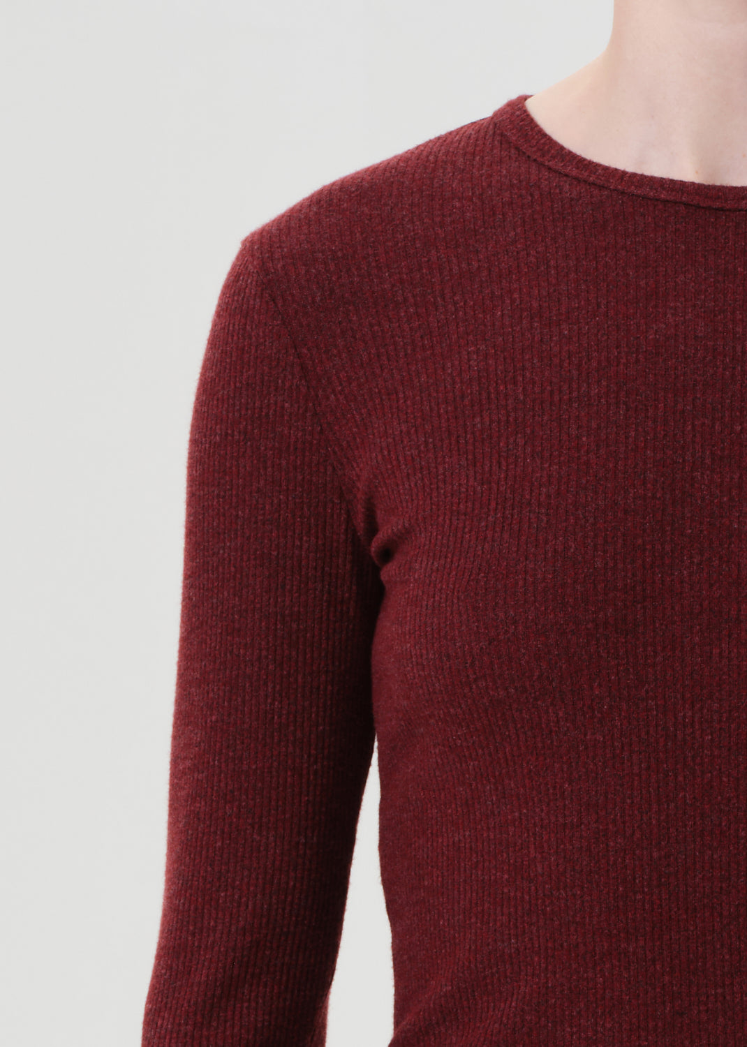 Close-up of a maroon sweater on a plain background