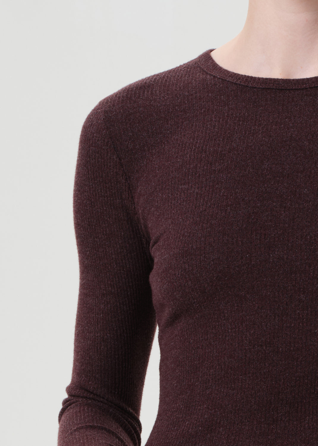 Close-up of a maroon sweater on a plain background