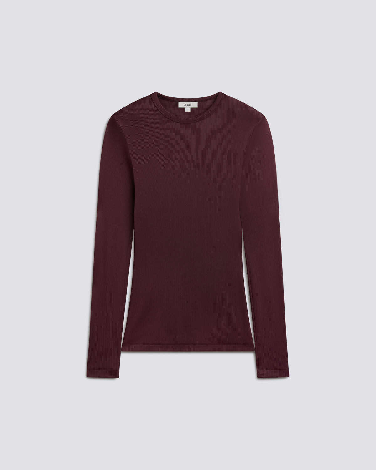 Flat lay of long sleeve burgundy shirt on a grey background