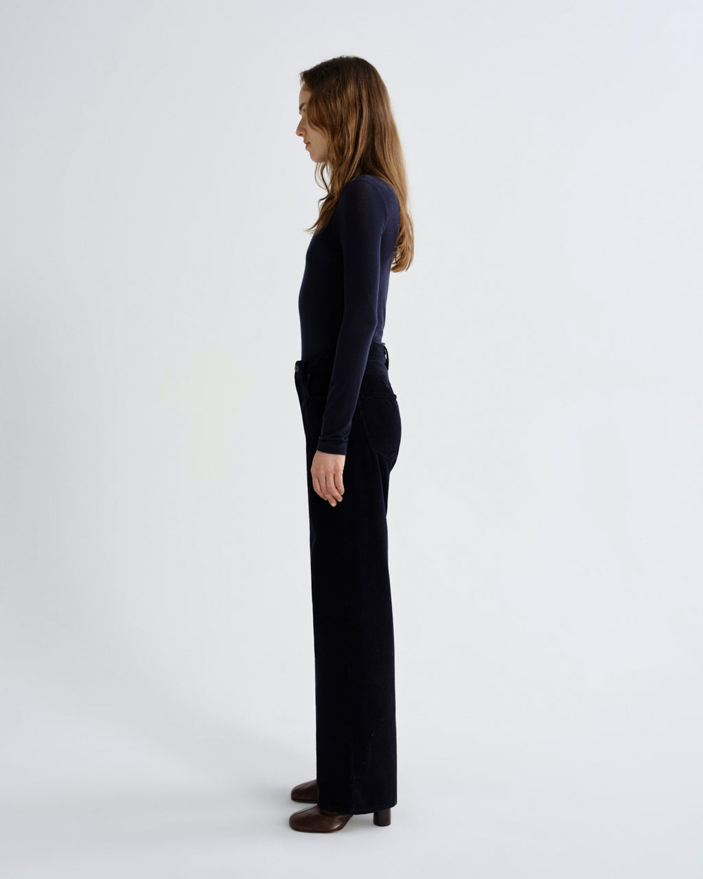 Person wearing a black outfit on a white background