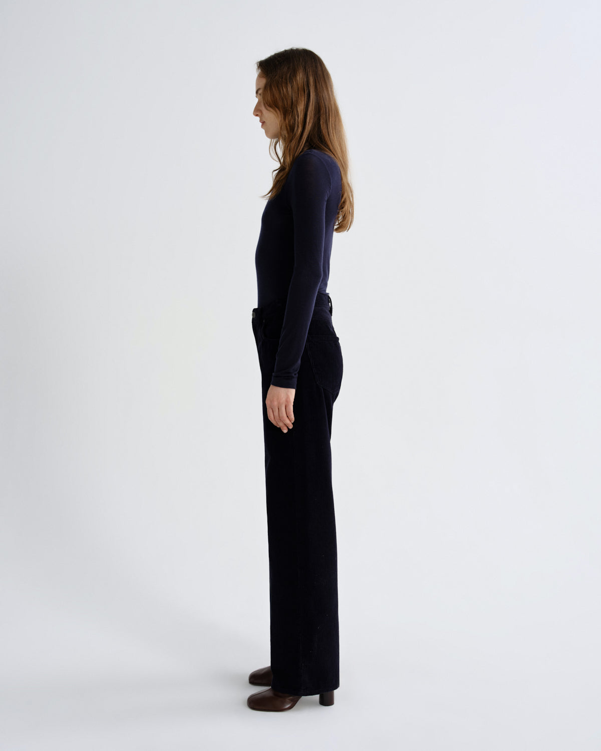 Person wearing a black outfit on a white background