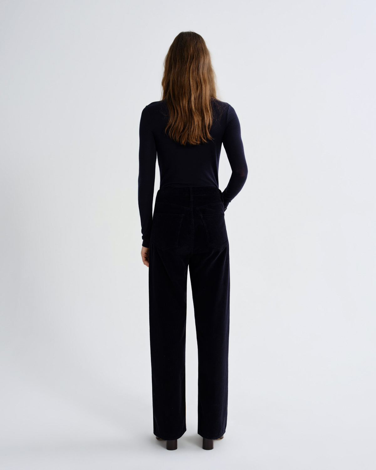 Person wearing a black outfit on a white background