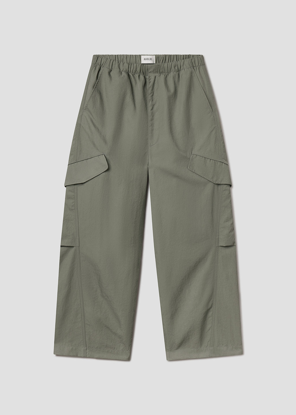 Flat lay of green pants on a grey background