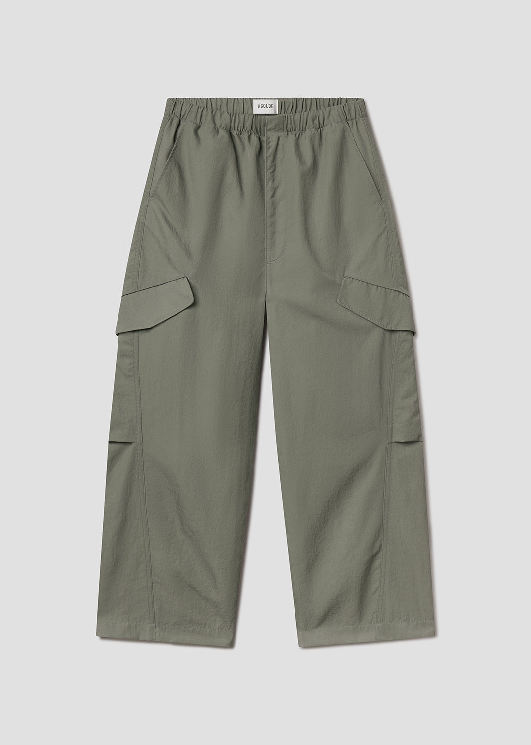 Flat lay of green pants on a grey background
