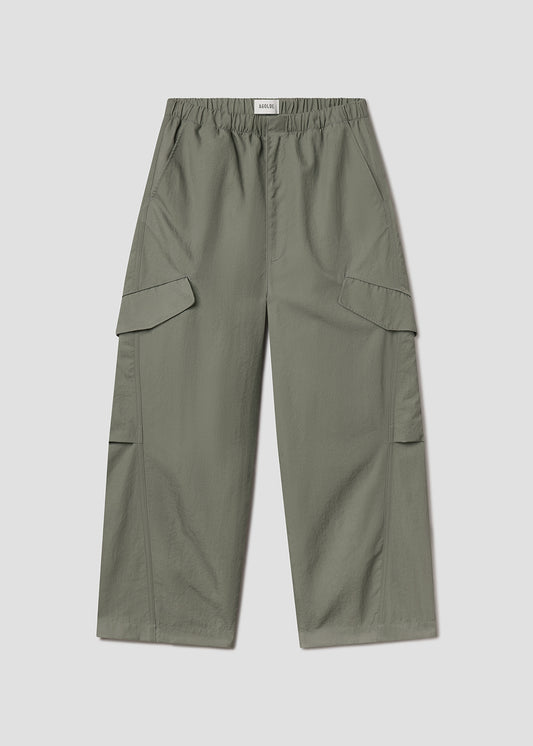 Flat lay of green pants on a grey background