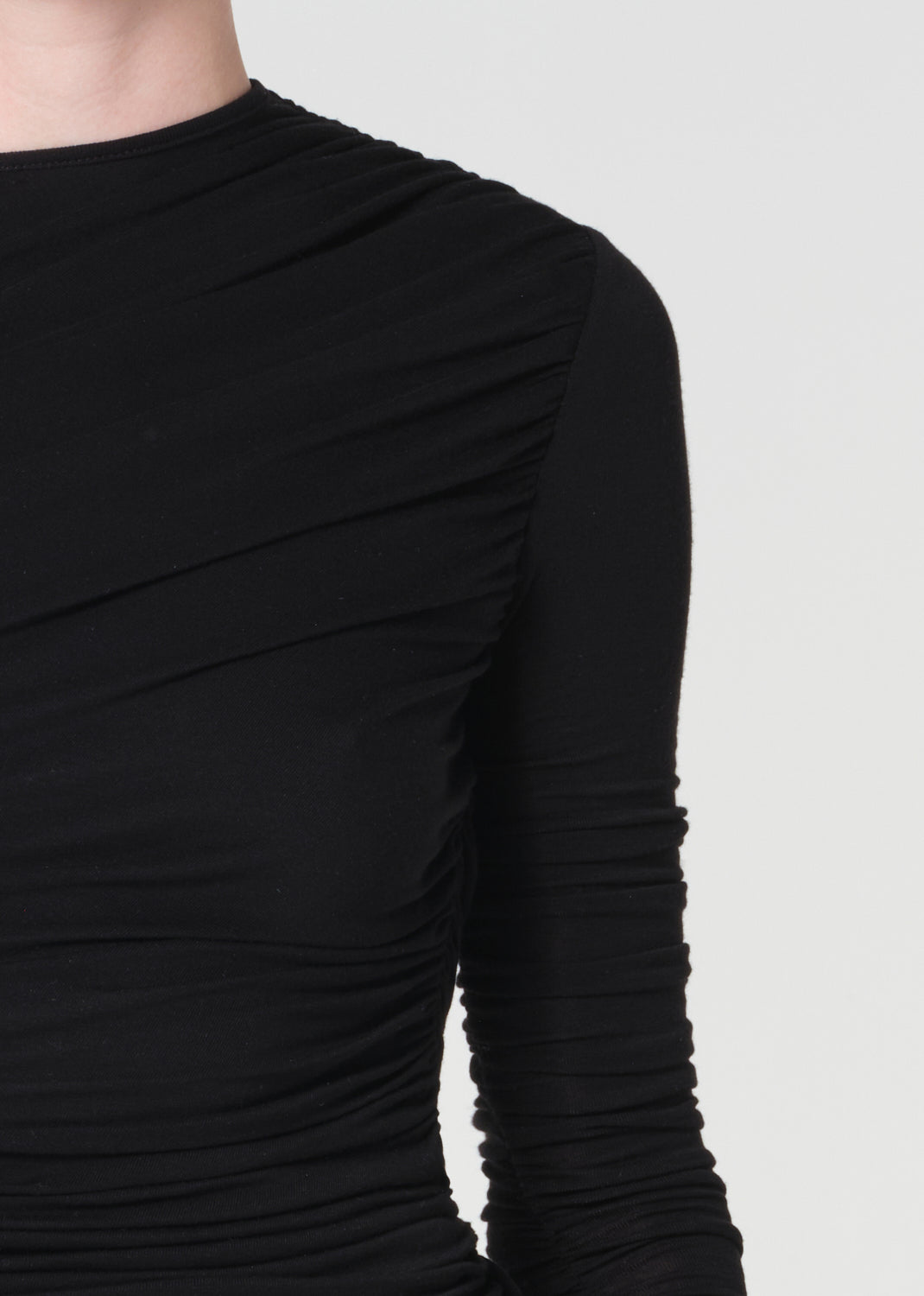 Black long-sleeve top on a plain background