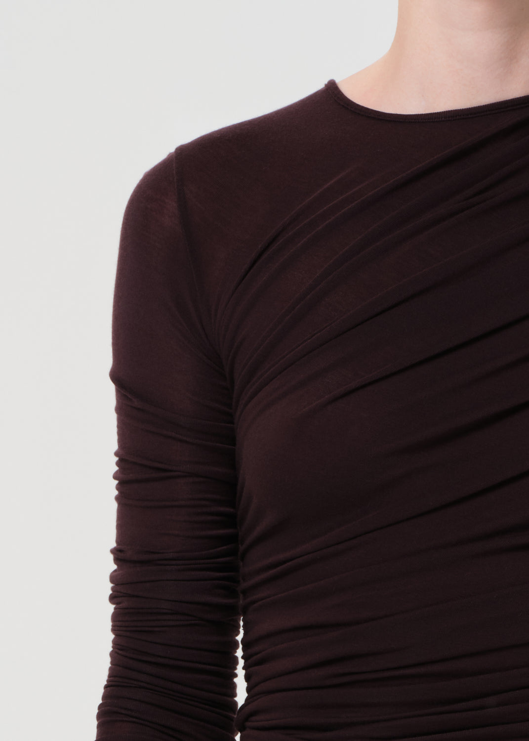 Brown long-sleeve top on a plain background