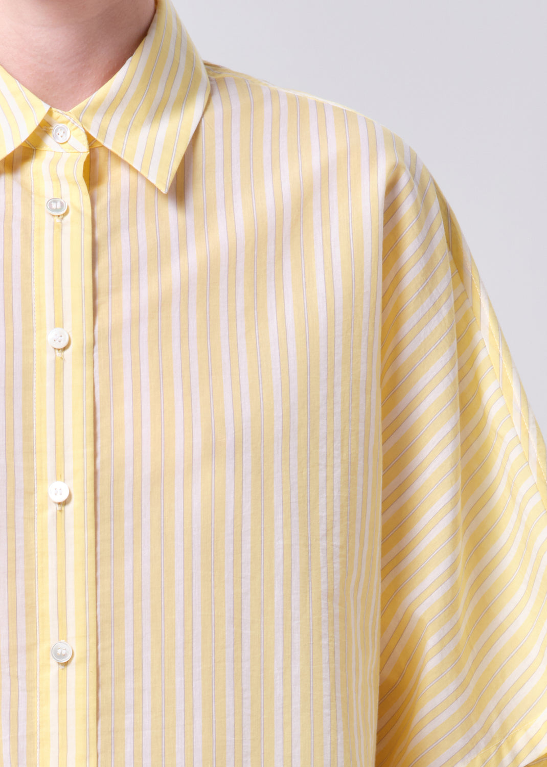 Yellow striped shirt with a plain background