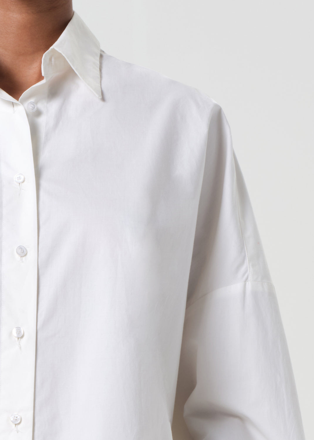 Close-up of a white shirt with a plain background
