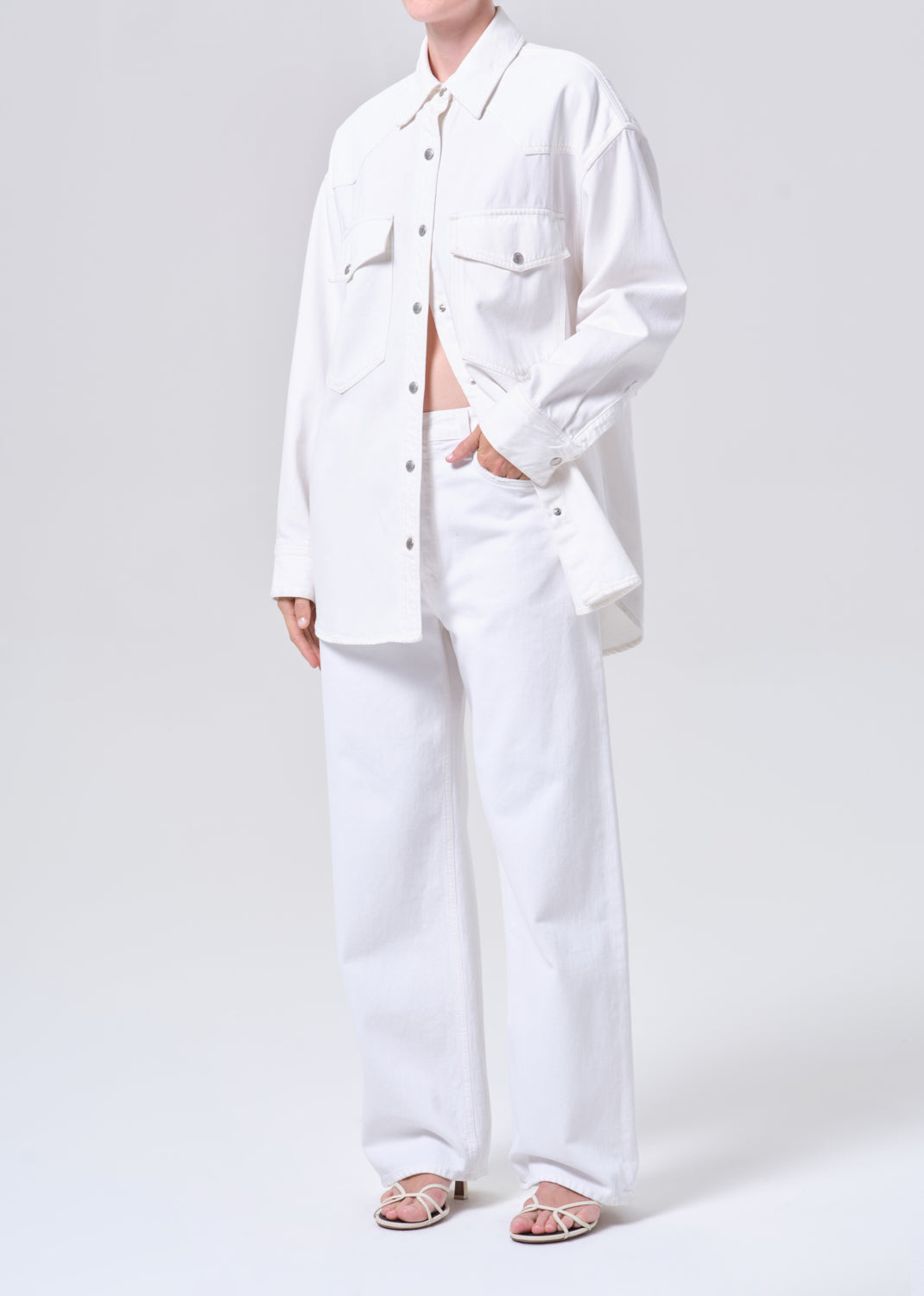 Person wearing a white outfit on a plain background