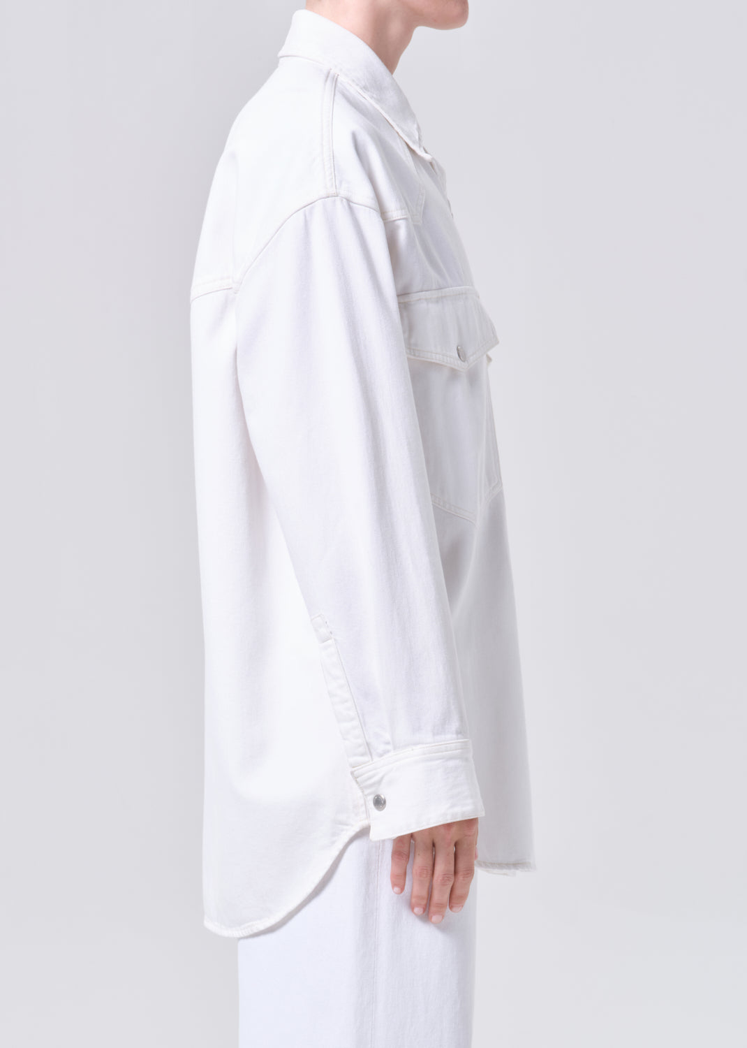 White shirt worn by a person on a light gray background