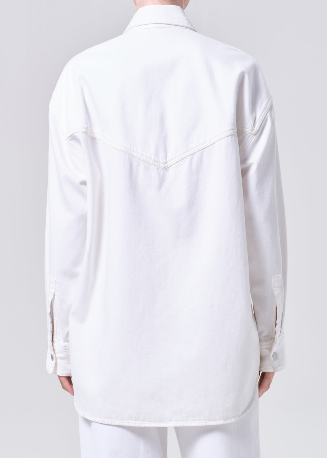 White shirt worn by a person on a plain background