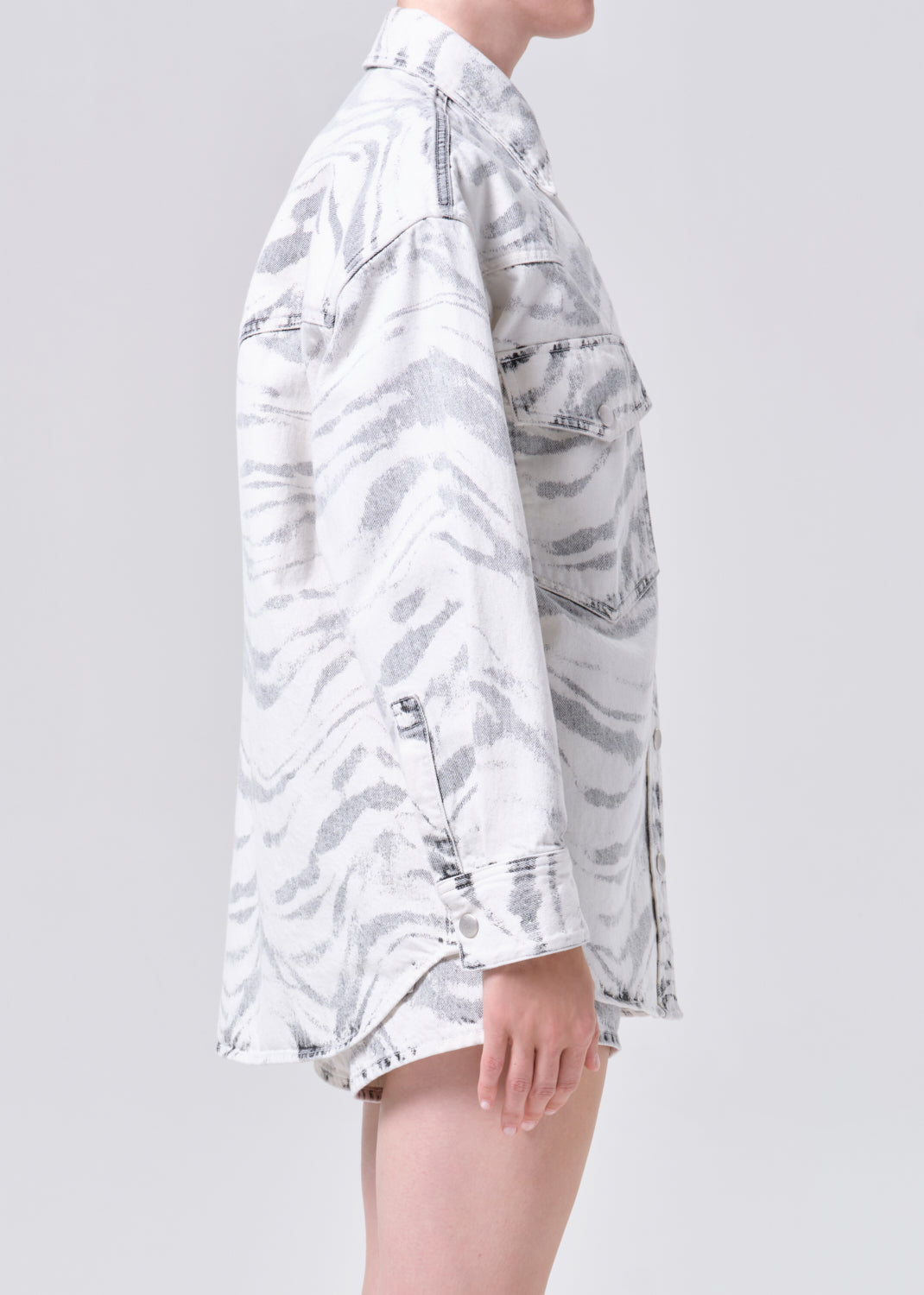 White camouflage shirt worn by a person on a light gray background