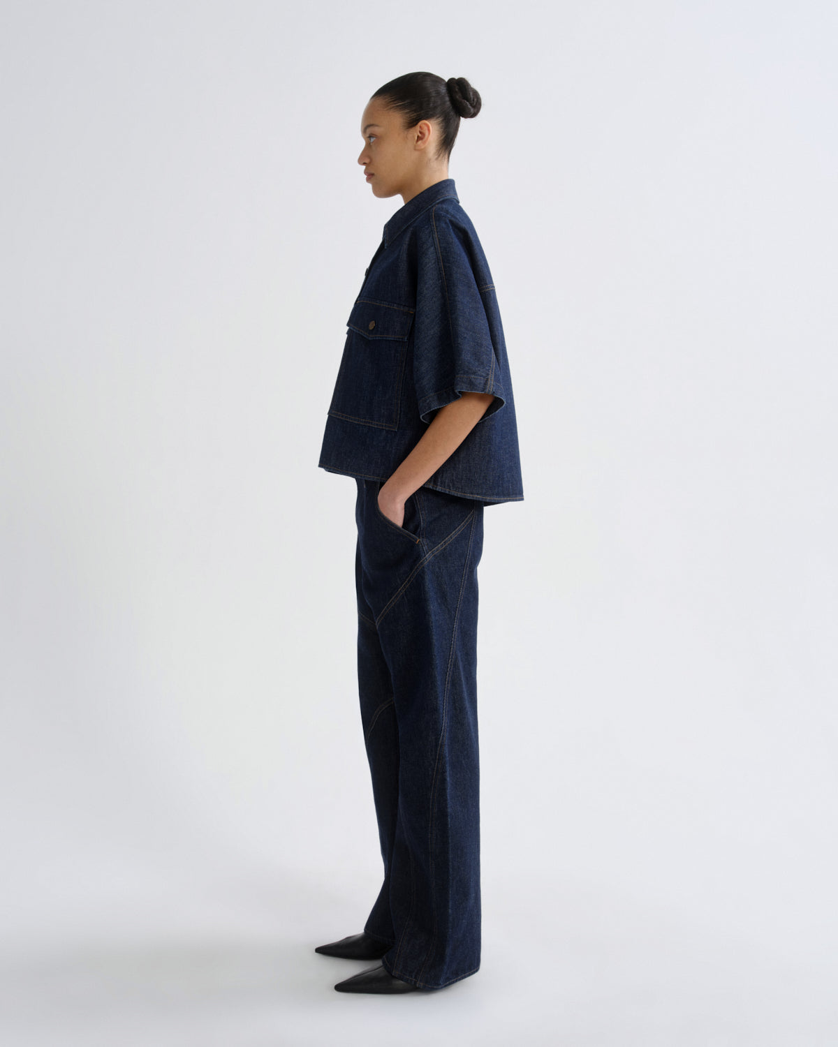 Person wearing a navy blue outfit on a white background
