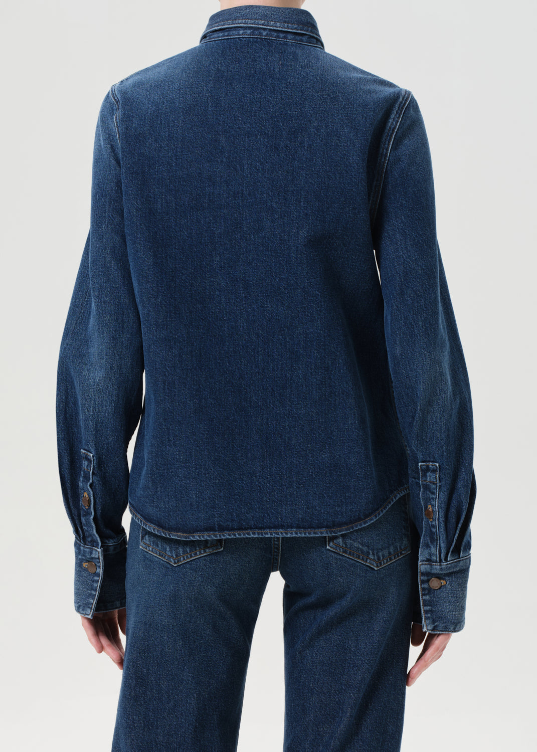 Blue denim jacket and pants on a white background