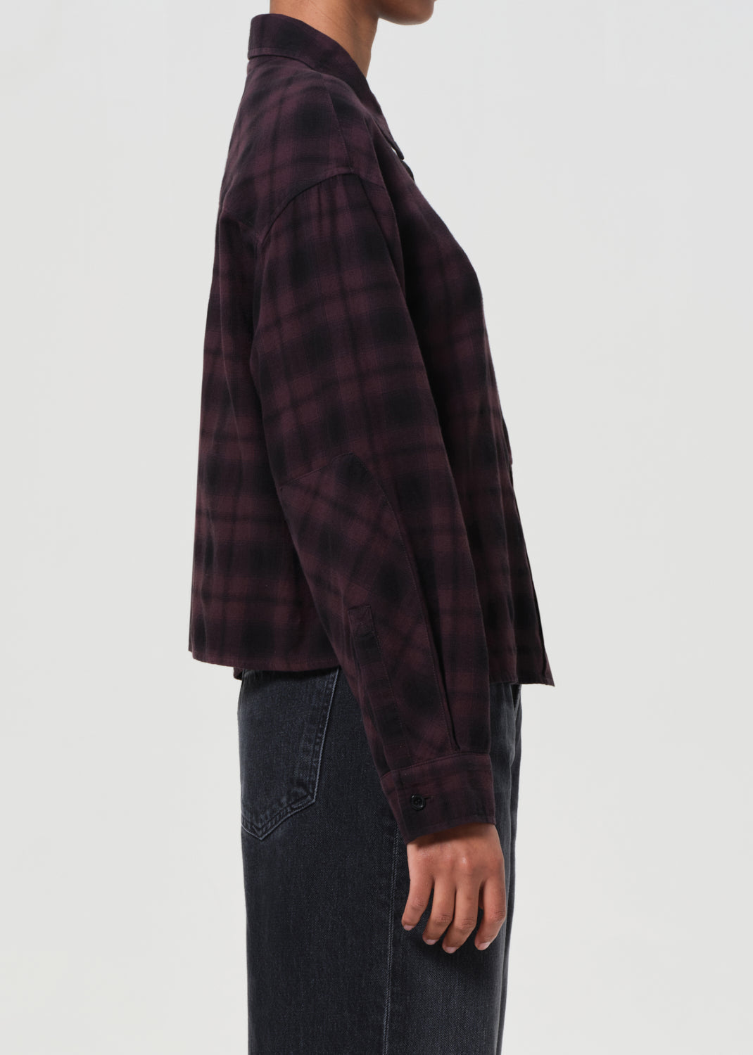 Plaid shirt worn by a person on a white background